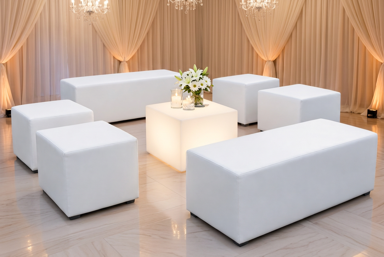 Essence lounge set with white bench seating and illuminated center cube inside a draped venue